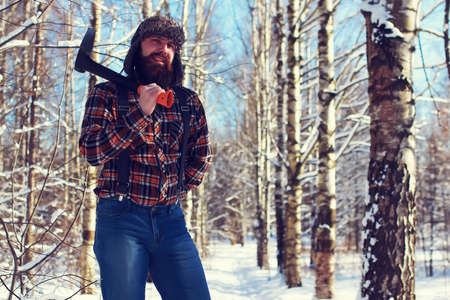 sun day man with axe in the forestの写真素材