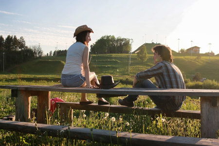 a couple of young people admire the sunset in the spring eveningの写真素材