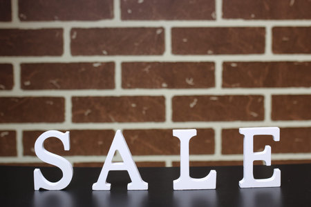 Trolley for products on a brick wall background New Years saleの写真素材