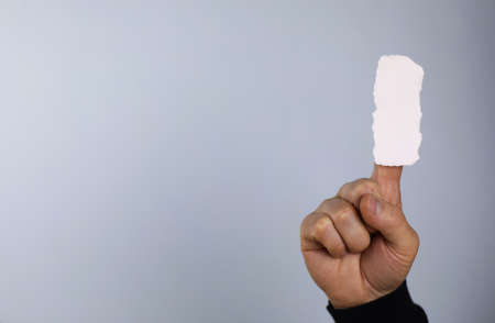 small white piece of paper in his hand manの写真素材