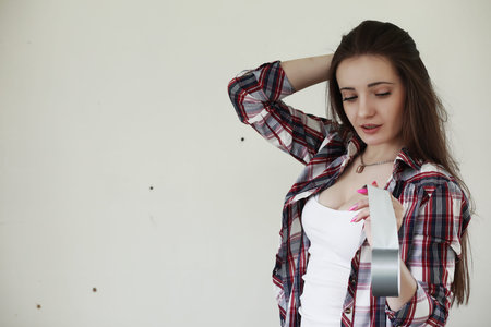 Girl doing repairs in the apartmentの写真素材