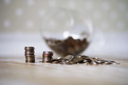 Coins stacked in piles on the floorの写真素材