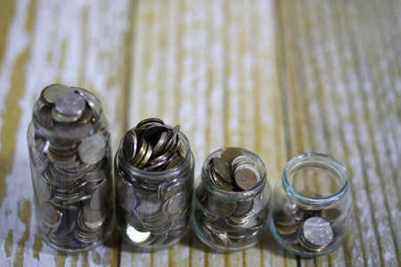 coins stacked in glass jars on the floor russian rublesの写真素材