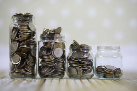 Coins stacked in glass jars on the floor russian rublesの写真素材