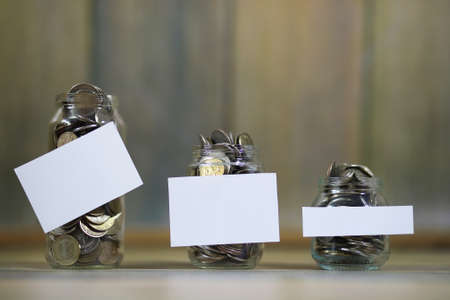 Coins stacked in glass jars on the floor russian rublesの写真素材