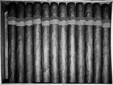 Retro styled photo of large box of Cuban cigars on a wooden tablの写真素材