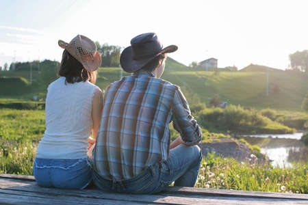 a couple of young people admire the sunset in the spring eveningの写真素材