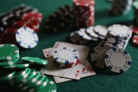 set of chips and cards on a green baize gambling casinoの写真素材