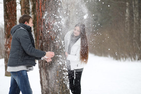 pair of lovers on a date winter afternoon in a snow blizzardの写真素材