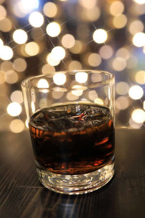 glass of cold alcohol drink with ice on the tableの写真素材