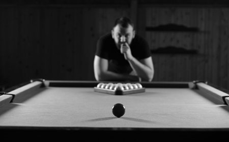 monochrome photo young man playing billiards