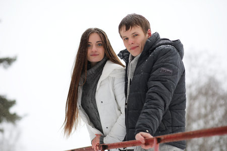pair of lovers on a date winter afternoon in a snow blizzard