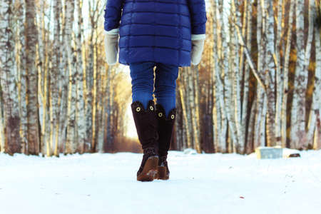 woman walk park winter snow backの写真素材