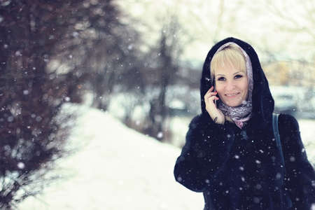 Girl Winter talk Phone snowの写真素材