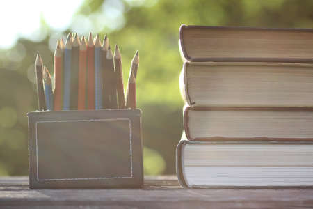 different objects on a wooden table on a background of blurred summer foliageの写真素材