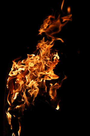 Tongues of a flame of fire of orange-yellow color from burning firewoodの写真素材