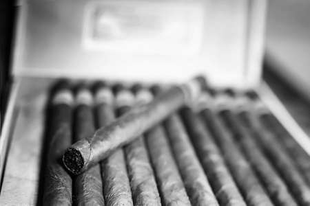 Retro styled photo of large box of Cuban cigars on a wooden table in a presentable packageの写真素材