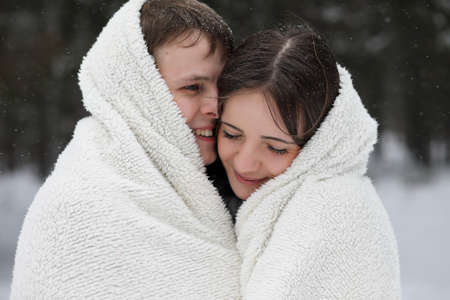 a pair of lovers on a date winter afternoon in a snow blizzardの写真素材
