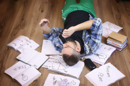 man working with book on the floorの写真素材