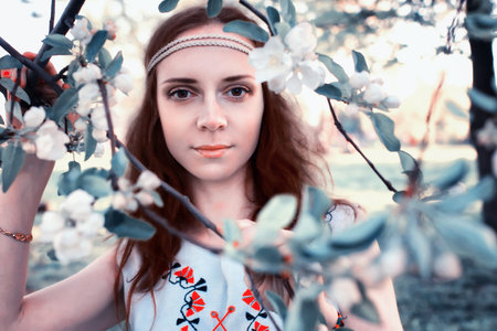 Girl in the spring walks through the apple alleyの写真素材