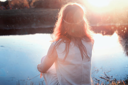 Girl in the spring walks through the apple alleyの写真素材
