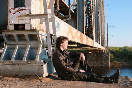 Man with an electric guitar in the industrial landscape outdoorsの写真素材