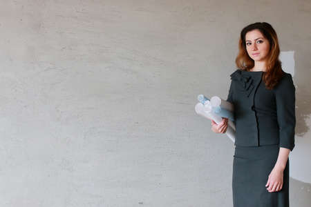 female architect at the construction site with drawings and noteの写真素材