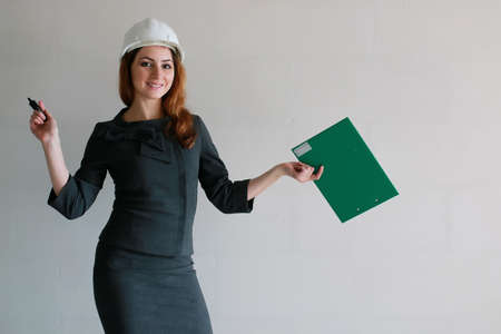 female architect at the construction site with drawings and noteの写真素材