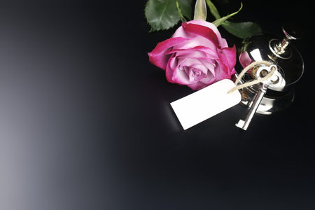 silver bell and the key at the reception in the hotel on a black background