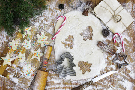 New Year delicacy cooking butter biscuits of different shapes on a wooden table with Christmas...