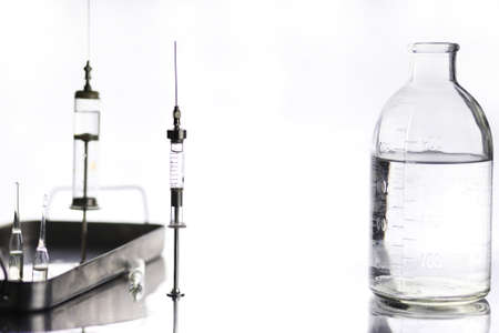 Old retro metal medical syringe and accessories on the tableの写真素材
