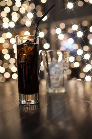 glass of cold alcohol drink with ice on the tableの写真素材
