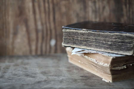 Old books on a wooden table and glass magnifierの写真素材