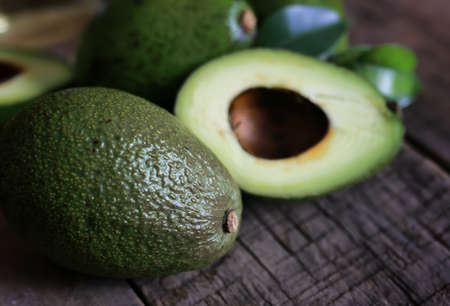 Fresh and juicy vegetables on a wooden table the texture of avocado on breadの写真素材