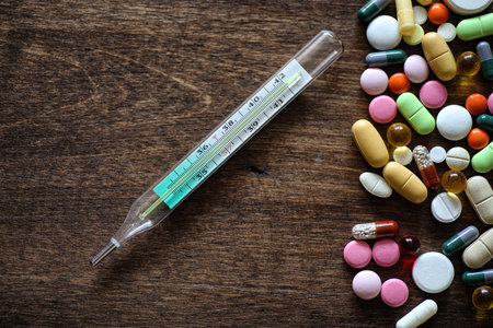 Medical background of various colorful medications on a textured wooden