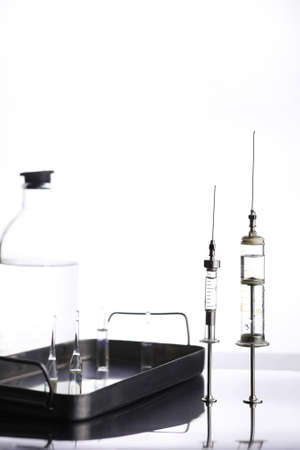 Old retro metal medical syringe and accessories on the tableの写真素材