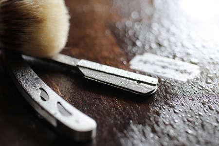 Shaving accessories on a wooden texture background and disposable bladesの写真素材