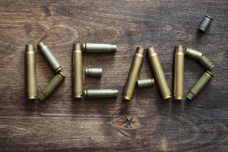 Cartridges on a wooden background inscription about the war