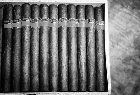 Retro styled photo of large box of Cuban cigars on a wooden table in a presentable package