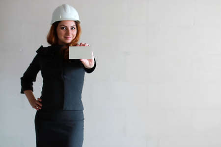 woman with a blank sheet of paper in his hand on construction siの写真素材