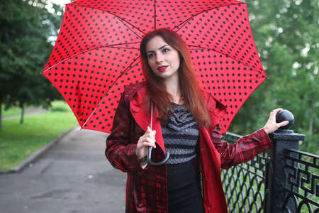 woman in a raincoat and an umbrellaの写真素材