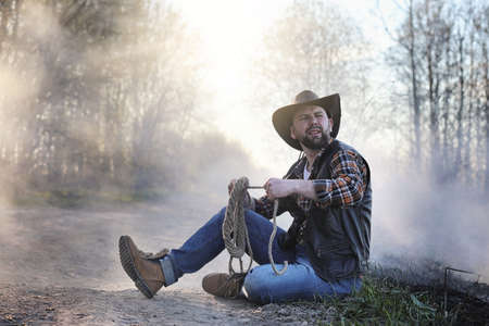 A cowboy in a thick smoke on the roadの写真素材