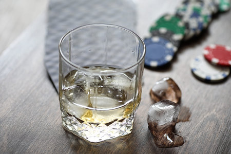 A glass of whiskey and ice on the table