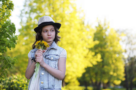 Girl in the park in the evening of a sunny day in the springの写真素材