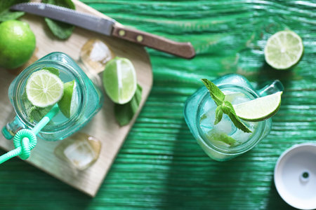 Lemonade from lime and mint in a glass jar on a table
