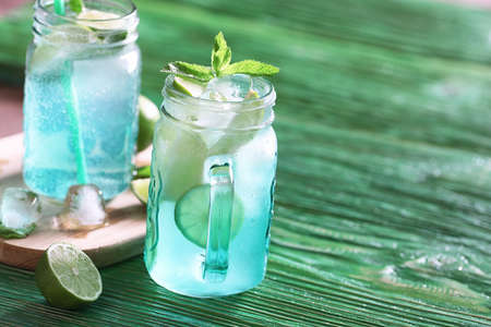 Lemonade from lime and mint in a glass jar on a tableの写真素材