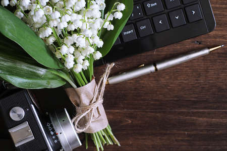Bouquet of young lilies of the valley on a wooden tableの写真素材