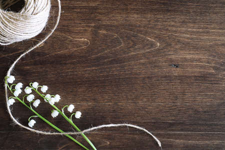 Bouquet of young lilies of the valley on a wooden tableの写真素材