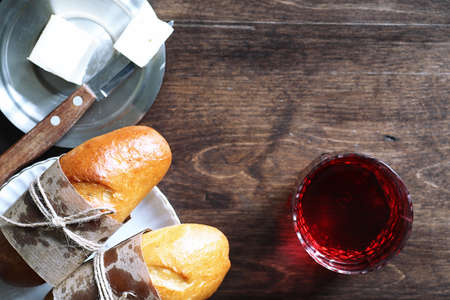 Freshly baked French baguette on a wooden table for breakfastの写真素材