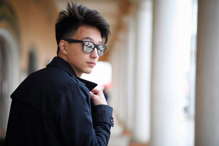 Asian young adult man on street posing at the cameraの写真素材